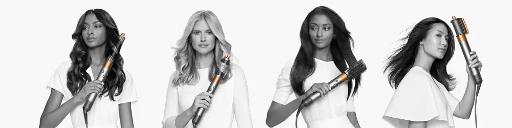 Four women using the Dyson Airwrap on their long hair, image in black and white
